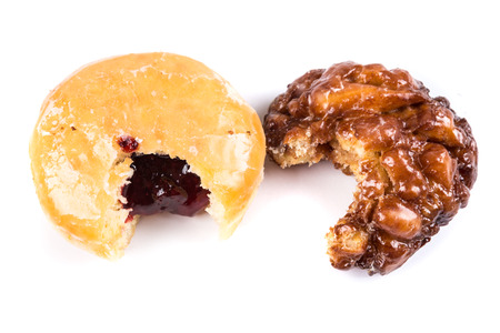 Partially eaten donuts with a bite taken out isolated on a white backgroundの写真素材