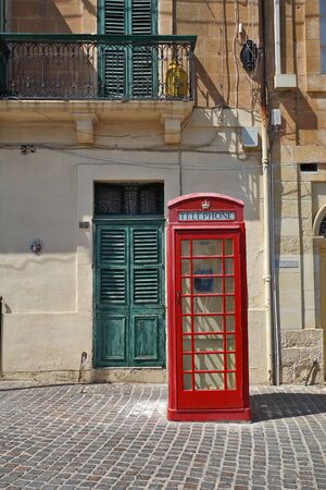 August 10th 2018, Malta: red vintage British telephone booth on Maltaの写真素材