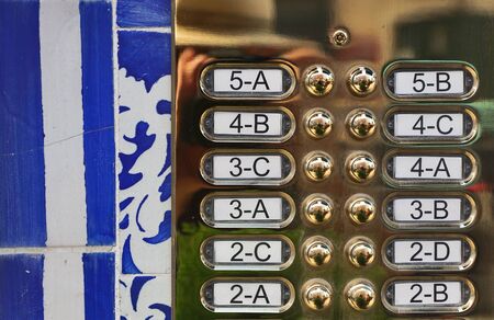 Anonymous decorative bell signs in Lisbon made of brass with Azulejo tiles