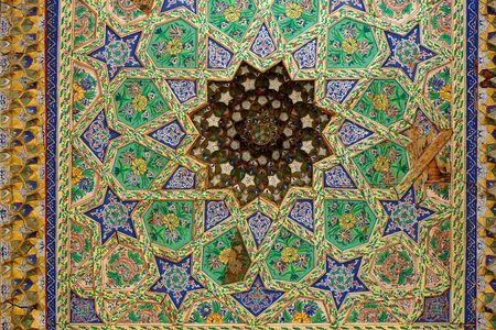 Oriental ornament art in Bukhara Uzbekistan on wooden pillars of a historic mosqueの写真素材