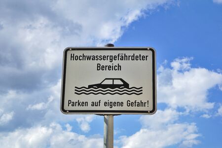 Sign: flood-prone area. Parking at your own risk!の写真素材