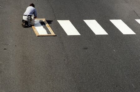 1986, TÃ¼bingen, Germany: craftsman paints zebra stripes by hand and brush on the streetの写真素材