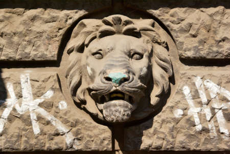 Relief of a lions head with graffiti on a building in Budapest, Hungary の写真素材