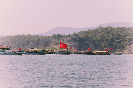 Azmak River, Akyaka, Mugla, Turkey. Nature composition. Summer Background. Countryside landscape with lake. Boat sails on the Azmak River. People are taking tour on Azmak River in Akyaka Village.のeditorial素材