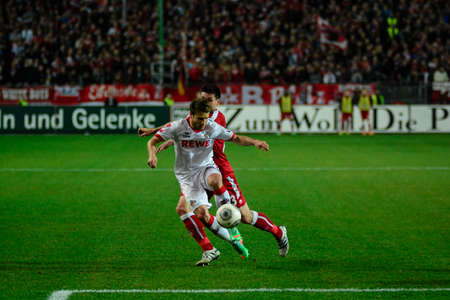 Midfielder DANIEL HALFAR (22) drives the ball past Defender FLORIAN DICK (23). The 1FC Kaiserslautern hosted the 1FC Koln at Fritz-Walter-Stadion in Kaiserslautern. のeditorial素材