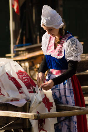 ALKMAAR, NETHERLANDS - APRIL 10: The centuries old cheese market in Alkmaar is by far the towns biggest tourist attraction. Every Friday morning from April through September at 10:00 the Waagplein (weighing square) comes to life, full of vendors sellingのeditorial素材