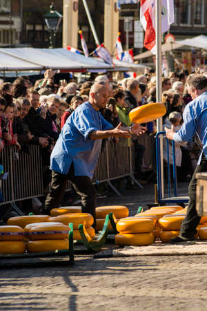 ALKMAAR, NETHERLANDS - APRIL 10: The centuries old cheese market in Alkmaar is by far the towns biggest tourist attraction. Every Friday morning from April through September at 10:00 the Waagplein (weighing square) comes to life, full of vendors selling tのeditorial素材