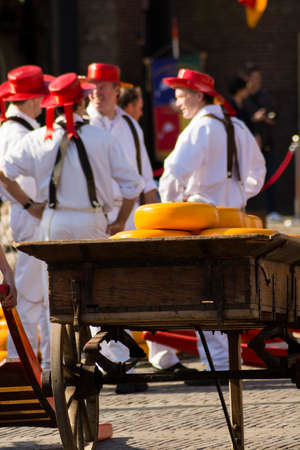 ALKMAAR, NETHERLANDS - APRIL 10: The centuries old cheese market in Alkmaar is by far the towns biggest tourist attraction. Every Friday morning from April through September at 10:00 the Waagplein (weighing square) comes to life, full of vendors sellingのeditorial素材