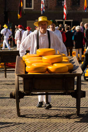 ALKMAAR, NETHERLANDS - APRIL 10: The centuries old cheese market in Alkmaar is by far the towns biggest tourist attraction. Every Friday morning from April through September at 10:00 the Waagplein (weighing square) comes to life, full of vendors sellingのeditorial素材