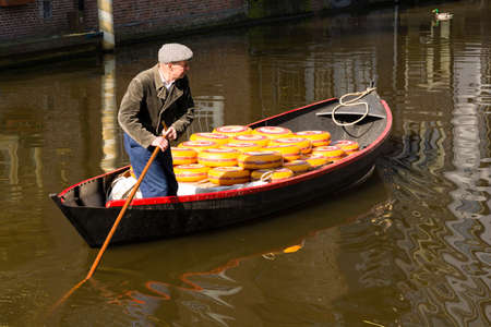 ALKMAAR, NETHERLANDS - APRIL 10: The centuries old cheese market in Alkmaar is by far the towns biggest tourist attraction. Every Friday morning from April through September at 10:00 the Waagplein (weighing square) comes to life, full of vendors sellingのeditorial素材