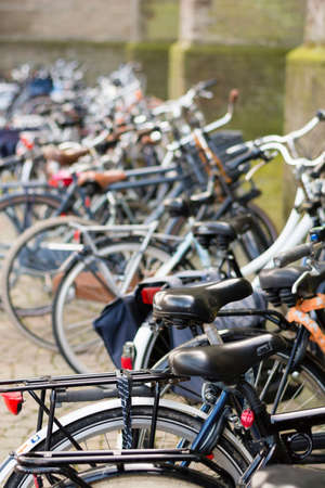 ALKMAAR, NETHERLANDS - APRIL 10: The centuries old  Laurens Church with bikes parked in a line along it's moss covered walls,  Alkmaar, Netherlands on April 10 2014.のeditorial素材