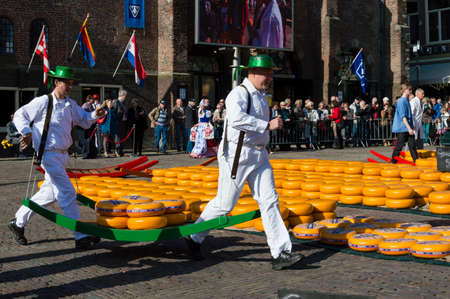 ALKMAAR, NETHERLANDS - APRIL 11: The centuries old cheese market in Alkmaar is by far the towns biggest tourist attraction. Every Friday morning from April through September at 10:00 the Waagplein (weighing square) comes to life, full of vendors selling tのeditorial素材