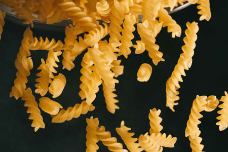 Flying pasta on dark background. Food motion.の写真素材