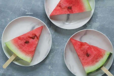 Portion slices of watermelon with wooden sticks