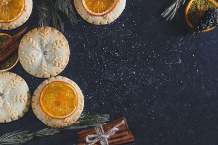 Top view of mince pies, baked crumbly pastry packed with fruits, tangy peel and spices. Concept of Christmas baking. Copy space.の写真素材