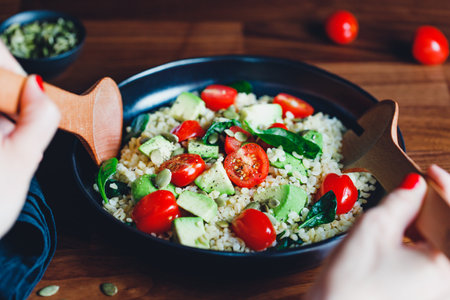 Healthy salad with bulgur, avocado, spinach and cherry tomatoes.の写真素材