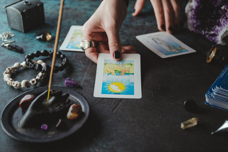 Witch predicts and reads the future through the use of Tarot cards. Mystical and occult concept.