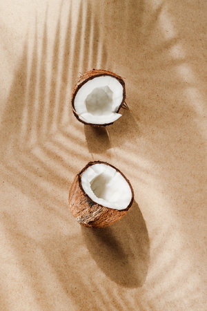 Summer abstract creative composition with coconut a on wooden tray over kraft paper.の写真素材