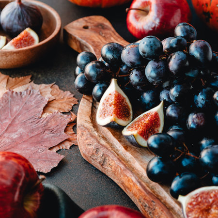 Autumn food, red apples, figs, grapes. Moody still life.の写真素材