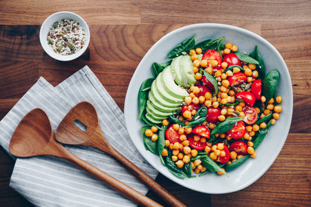 Fresh healthy salad with chickpea, avocado, cherry tomatoes and spinach.の写真素材