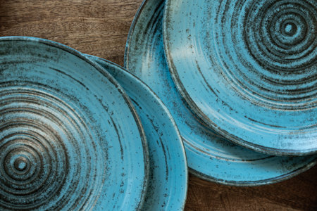 Empty blue ceramic plates on wooden background. Copy space for text.の写真素材