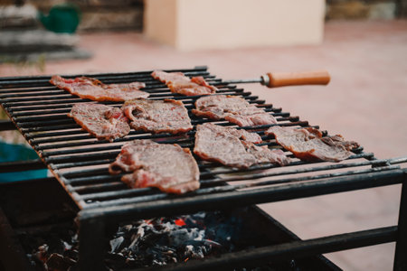 Fresh meat steaks on a grill, summertime backyard dinner conceptの写真素材
