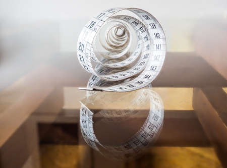 Tape measure, used by dressmakers and tailors to take measurements of the clothes to be made.の写真素材