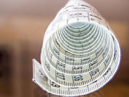 Tape measure, used by dressmakers and tailors to take measurements of the clothes to be made.の写真素材