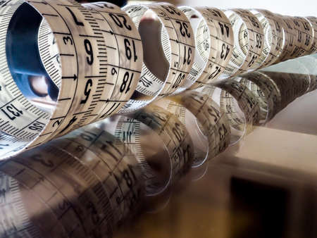 Tape measure, used by dressmakers and tailors to take measurements of the clothes to be made.