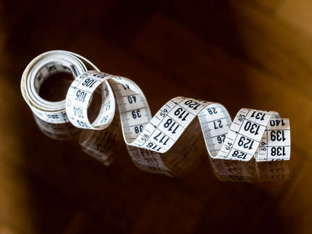 Tape measure, used by dressmakers and tailors to take measurements of the clothes to be made.