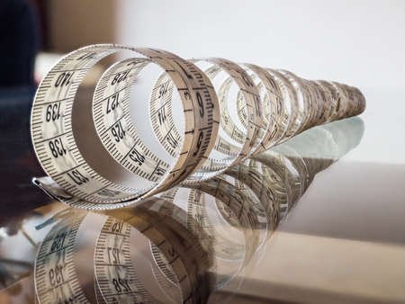 Tape measure, used by dressmakers and tailors to take measurements of the clothes to be made.の写真素材
