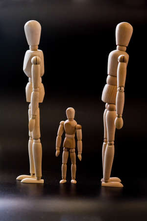 Mannequins and architectural game pieces on a black backgroundの写真素材