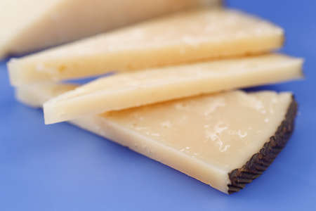 Cured Manchego cheese, derived from sheep's milk. Dairy product, for food.