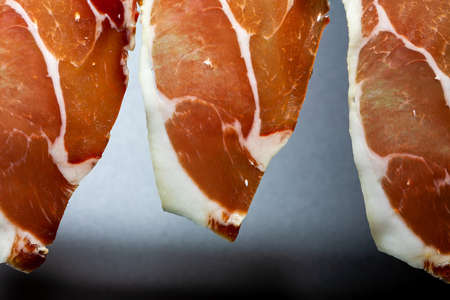 Slices of Serrano ham. Typical product of the pig, is obtained from the pork put in salted and cured in the air of the sierra.の写真素材