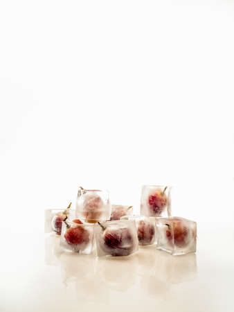 Grape inside ice on white backgroundの写真素材