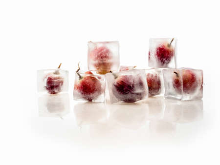 Grape inside ice on white backgroundの写真素材
