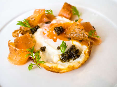 fried egg with salmon and caviar