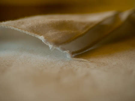 Folded tablecloth, reflected on a transparent glass table.