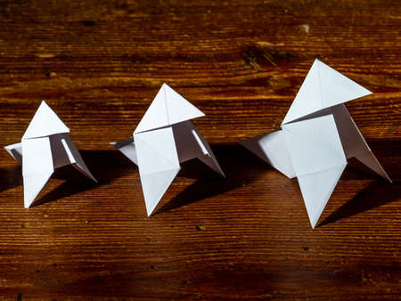 Bow tie made with white paper, reflected on a shiny black backgroundの写真素材