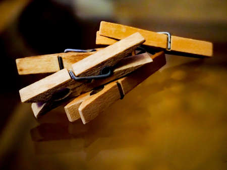 Clothespins, reflected on a shiny glass backgroundの写真素材