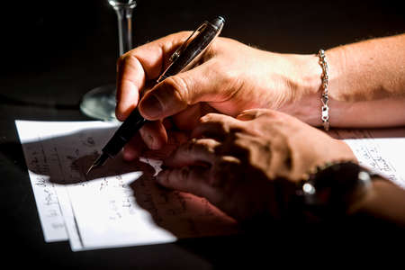 A writer dumps his ideas on paper with his fountain penの写真素材