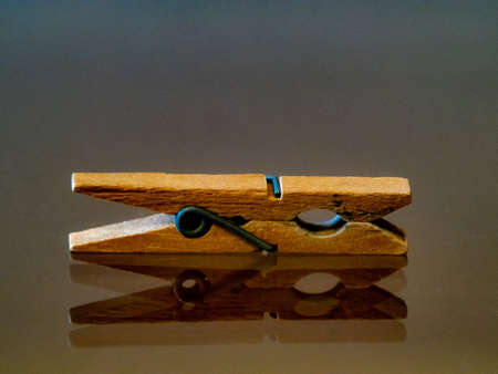 Clothespins, reflected on a shiny glass backgroundの写真素材
