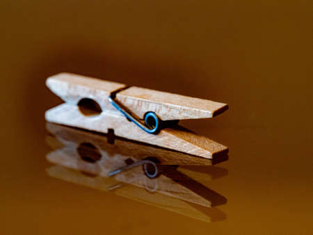 Clothespins, reflected on a shiny glass backgroundの写真素材
