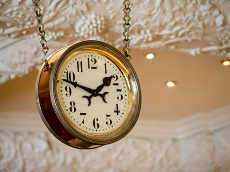 clock hanging on two chainsの写真素材