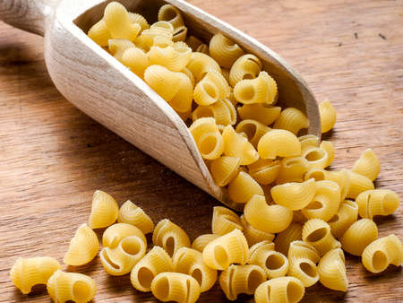 Still life short durum wheat pasta on a wooden table