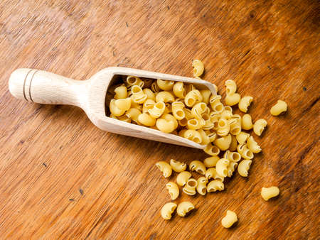 Still life short durum wheat pasta on a wooden table