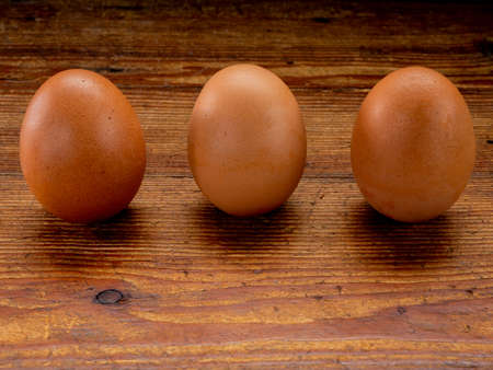 Group of eggs in balance on a wooden base