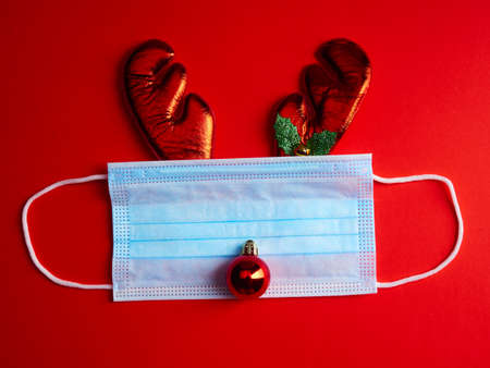 Festive Christmas reindeer made with surgical mask and Christmas decorationsの写真素材