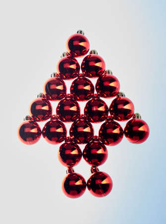 Shiny red Christmas balls placed in the shape of a fir tree