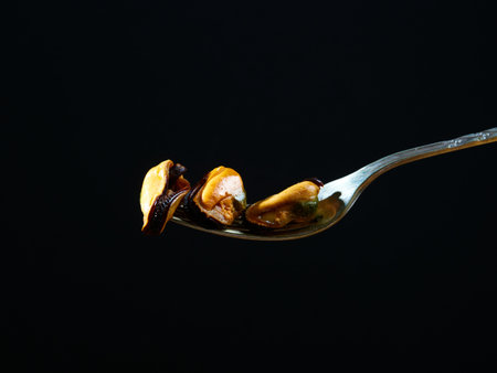 Mussels on a fork in the darkの写真素材